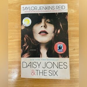 Daisy Jones & The Six, a novel by Taylor Jenkins Reid. Paperback copy.